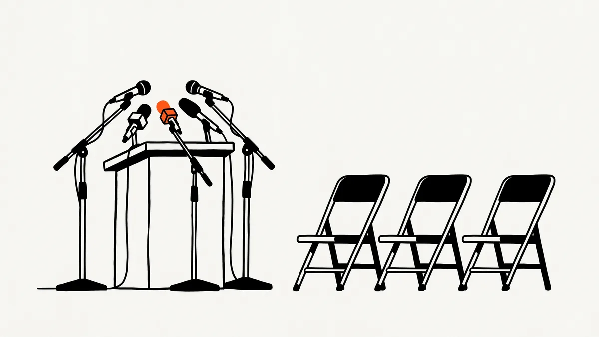 Ilustrasi podium dengan beberapa mikrofon dan deretan kursi kosong yang menghadap ke podium, satu mikrofon berwarna oranye